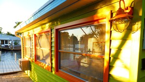A green building with a window and a door. - Vacation fun at a bargain price—now with huge discounts! (Matlacha)