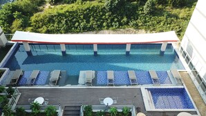 A rooftop swimming pool with lounge chairs and a covered area. - Andong CM Park Hotel (Yecheon)