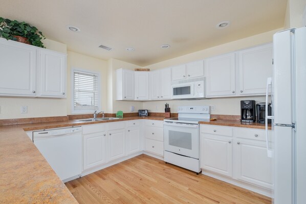Enjoy cooking in this well-equipped kitchen with a microwave, coffee maker, and dishwasher.