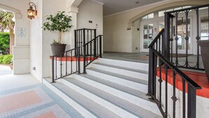 A staircase with black railings and red steps leading to an upper floor. - Oceanfront 2-bedroom condo at North Topsail Beach, perfect for family getaways. (North Topsail Beach)
