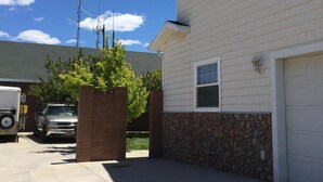 A residential building with a garage, a driveway, and a truck parked in the driveway.