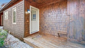 A wooden cabin with a front porch, a door, and a window. - Glazebrook J5: 3-Bedroom Townhome with Sauna & Fireplace (Killington)