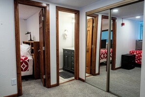 A bedroom with a bed, a dresser, and a mirror. - Ski-in/Walk-out condo,  free wifi, covered parking. kitchen, pet friendly! (Copper Mountain)