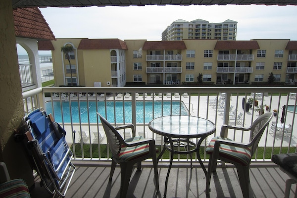 Balcony overlooks Olympic size pool, kiddie pool and courtyard, ocean to east.