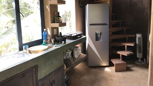 A compact kitchen with a sink, a refrigerator, and a stove.