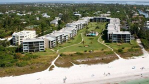Een resort met meerdere gebouwen, een strand en een zwembad.