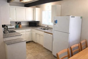 Fridge, microwave, coffee/tea maker, cookware/dishes/utensils