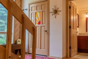 Enjoy the serene view from the window, where a cozy bench invites you to sit and unwind.