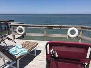 A wooden deck with lounge chairs and a lifebuoy. - Relax and Renew on your private deck overlooking the Chesapeake Bay (Silver Beach)