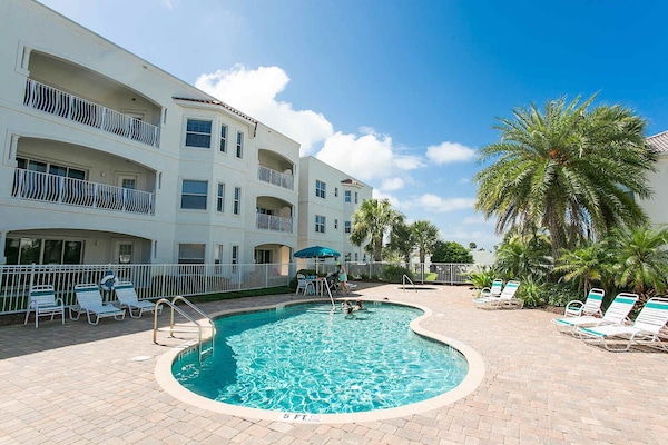 - Sparkling outdoor pool with palm trees and lounge seating nearby
- Perfect for swimming, sunbathing, or unwinding on warm afternoons
- Enjoy tropical vibes just steps away from your beach condo stay