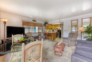 Relax in this inviting living space with a comfortable sofa, TV, and dining area.