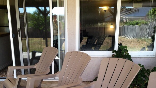 Three beige plastic chairs arranged on a concrete patio with a glass door and window in the background. - Large house in Silicon Valley - 40 min from San Francisco near Levi's Stadium (Santa Clara)