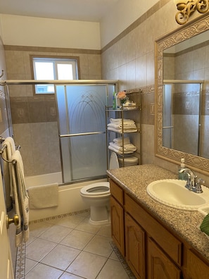 Combined shower/tub, hair dryer, towels, soap