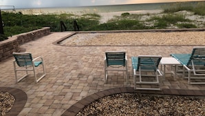 A patio area with brick flooring, a pool table, and several lounge chairs. - Cocoa Beach Paradise - direct ocean (Cocoa Beach)