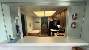 A modern kitchen with a white countertop, a built-in microwave, and a stainless steel refrigerator. - Cocoa Beach Paradise - direct ocean (Cocoa Beach)