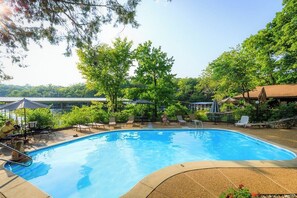A swimming pool with lounge chairs, surrounded by trees and a covered area. - Tree Top 16 - Two Bedroom House, Sleeps 6 (Four Seasons)
