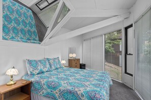 A bedroom with a bed, a nightstand, a dresser, and a skylight. - Tree Top 16 - Two Bedroom House, Sleeps 6 (Four Seasons)