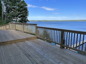 Enjoy the serene views from this deck overlooking a peaceful body of water.