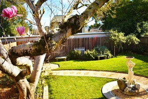 Stroll through this serene garden, surrounded by lush plants and a soothing fountain.
