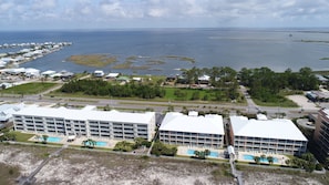 Un hôtel situé sur la côte, composé de plusieurs bâtiments, doté d’une piscine et offrant une vue sur l’océan et les îles.