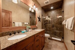 A bathroom with two sinks, a large mirror, a star decoration, and a shower area. - Spacious Park City 4BR, Walk to Three Kings Lift, Mountain Views, Pool  & Hot Tu (Park City)