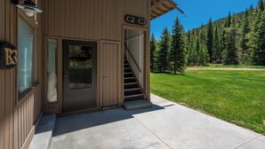 A two-story wooden building with a staircase leading to the second floor. - Cozy Ski-in/Walk-out condo, free wifi, & parking, great value (Copper Mountain)