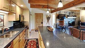 A spacious kitchen with granite countertops, wooden cabinets, and a central island. - 🌲Timberline A2D Deluxe 2-Bedroom ~Hot Tub~Pool~WiFi~Ski-in/out~Local Shuttle🌲 (Snowmass Village)