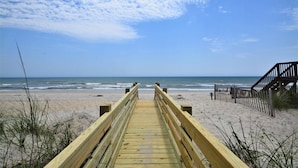 A wooden boardwalk leading to a beach with a wooden staircase on the right. - Experience beachside bliss at Almost Heaven North, a spacious 4-bedroom duplex in North Topsail! (North Topsail Beach)