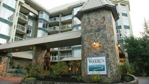 Een meerhoog hotel met een stenen zuil waarop een bord staat met de tekst 'Woodrun on Blain Canyon'.