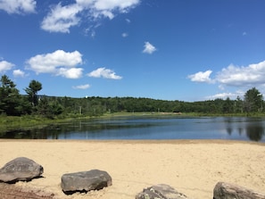 Escape to a serene lakeside haven with a sandy beach and tranquil surroundings.