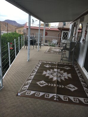 Relax in a secure, scenic setting with a casual dining area featuring a patterned rug and comfortable seating.