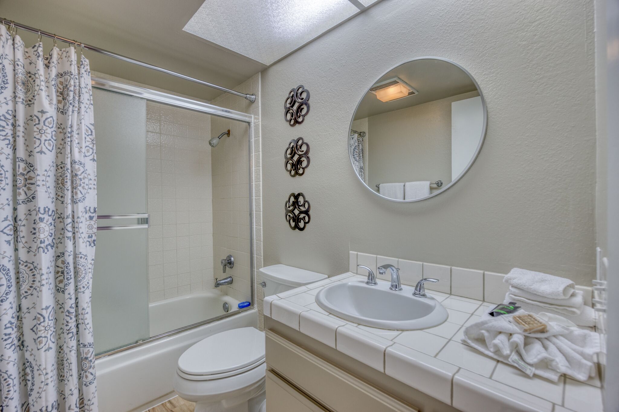 A bathroom with a bathtub, toilet, and sink.