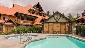 A swimming pool with a 'No Diving' sign, surrounded by buildings with a traditional architectural style. - Renovated, Whistler Village Condo, Private Hot Tub, BBQ & Pool Access. (Whistler)