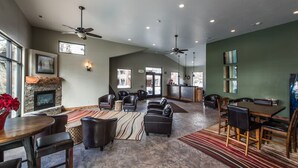 A spacious living room with a fireplace, leather sofas, a dining area, and a kitchen in the background. - Sunlit Park City 3BR+Loft Sleeps 8, In-Unit Laundry-Walk to Park City Resort (Park City)