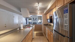 A modern kitchen with wooden cabinets, stainless steel appliances, and a built-in microwave. - Sunlit Park City 3BR+Loft Sleeps 8, In-Unit Laundry-Walk to Park City Resort (Park City)