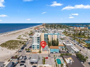 Aerial view of vacation rental with coral front doors, marked by a red location pin. - Bright Beach Cottage w/ Patio l  Steps to the Beach & Restaurants l  Pet-Friendly (Clearwater)