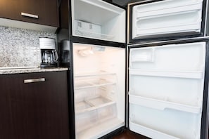 Enjoy cooking in this fully equipped kitchen with a refrigerator and coffee maker.