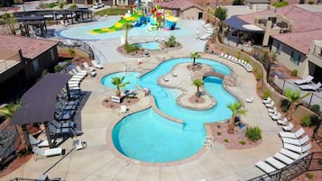 Un complexe hôtelier doté de plusieurs piscines, d’un parc aquatique et d’espaces de détente avec des chaises longues.