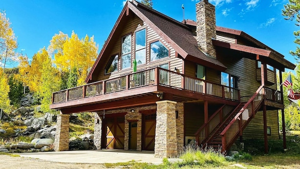 A two-story log cabin with a balcony and a chimney. - One of the Most Desirable Properties in the Winter Park / Fraser Valley (Tabernash)