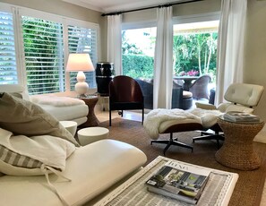 A well-lit living room with a sofa, armchairs, a coffee table, and a lamp. - Luxe East Boca Retreat – Private Home w/ Resort Pool, Perfect Location! (Boca Raton)
