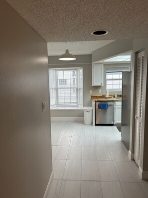 Modern kitchen with central island, dishwasher, and ample counter space.