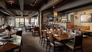 A restaurant with multiple dining tables, chairs, and a bar area. - 🌲Timberline 116 Studio Deluxe ~ Hot Tub~Pool~WiFi~Ski-in/out~Local Shuttle🌲 (Snowmass Village)