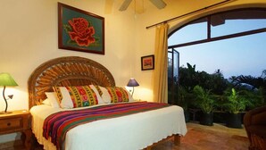 A bedroom with a large bed, a wooden headboard, and a view of the outdoors through a large window. - Private Dipping Pool. Ocean Views. (Casita #4) (Sayulita)