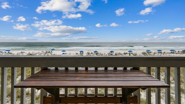A wooden deck with a view of the beach and ocean. - 🏖️Beautiful 2 BR / 2BTH Beachfront Condo with Community Swimming Pool! (Pensacola Beach)