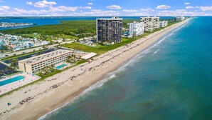 A coastal hotel with multiple buildings, a beach, and a pool area. - Beach Condo/ Island Beach Resort/No Cleaning Fee/ Condo 308 (Jensen Beach)