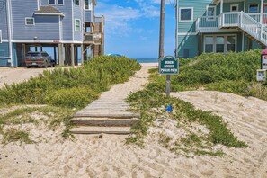 A pathway leading to a beach with a sign indicating public access. - 7BR Coastal Escape ,Ocean and Sound Views, Pool, Hot Tub & Pet Friendly (Rodanthe)