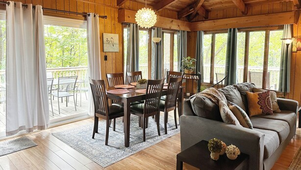 A cozy wooden interior with a dining area, a sofa, and large windows. - Bedrooms 4, Bathrooms 2, Sleeps 10 (Front Royal)