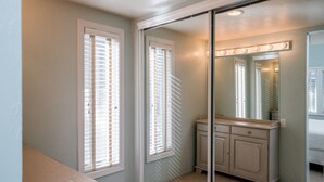A bathroom with a vanity, a mirror with lights, and a window with blinds. - 5-Min Walk to Warm Springs Ski Lifts (Ketchum)