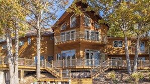 A multi-story log cabin with balconies and a staircase. - Hook Lane - Seven Bedroom House, Sleeps 18 (Camdenton)