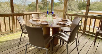 Someplace Else: Cheerfully decorated island home with marsh views.